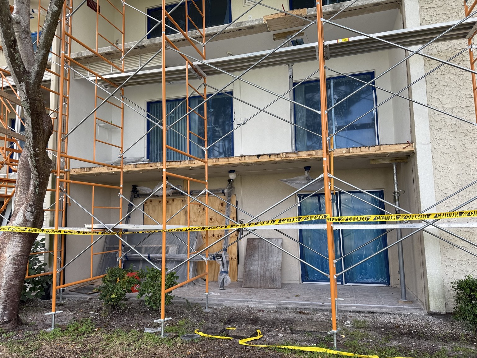 Scaffolding and protected windows during exterior repairs